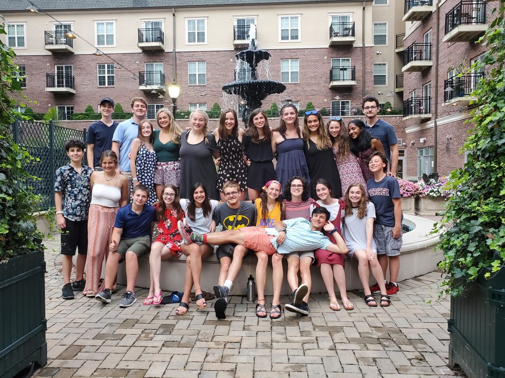 Teens posing in front of a water fountain